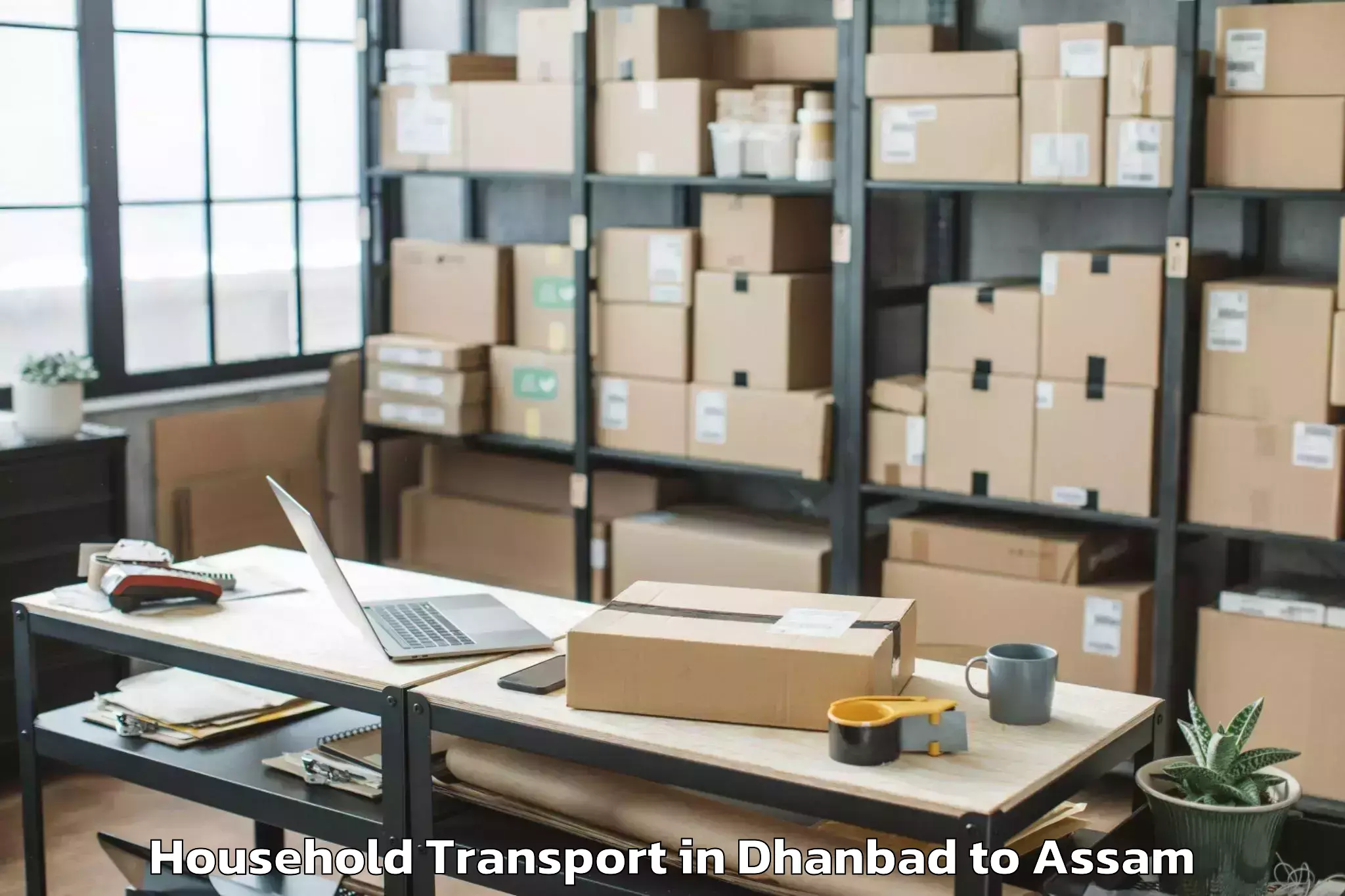 Book Dhanbad to Morigaon Household Transport Online